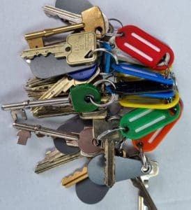key holding a large bunch of keys to secure properties during mobile patrols.