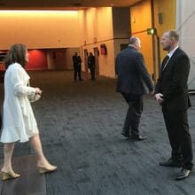 corporate security officer checking delegates' IDs and passes at a corporate event.
