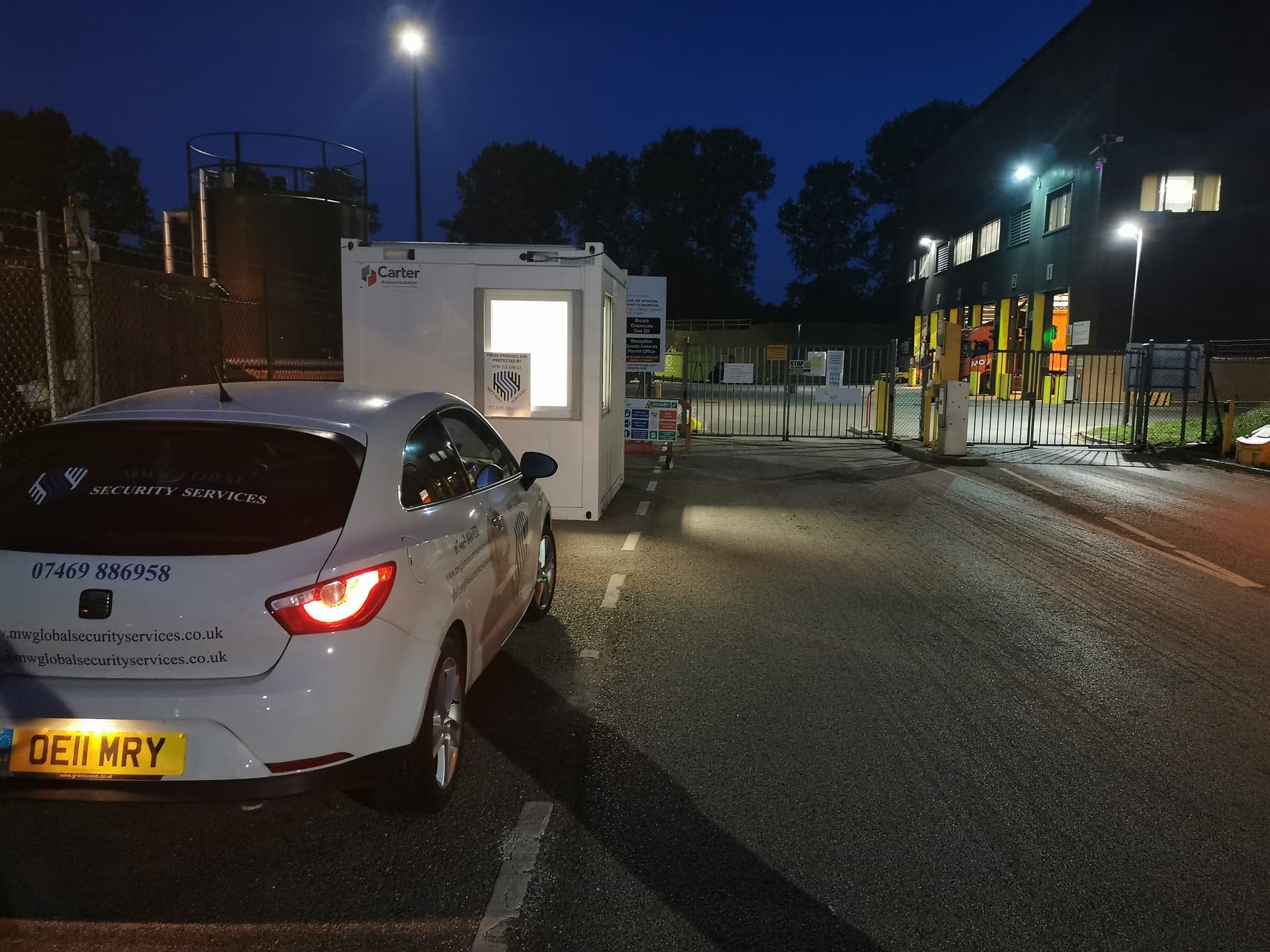Gatehouse security cabin protecting an industrial entrance during night operations