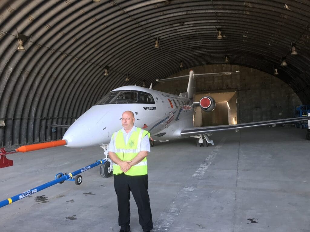 MW Global security officer protecting an aircraft inside an airfield hangar in Suffolk