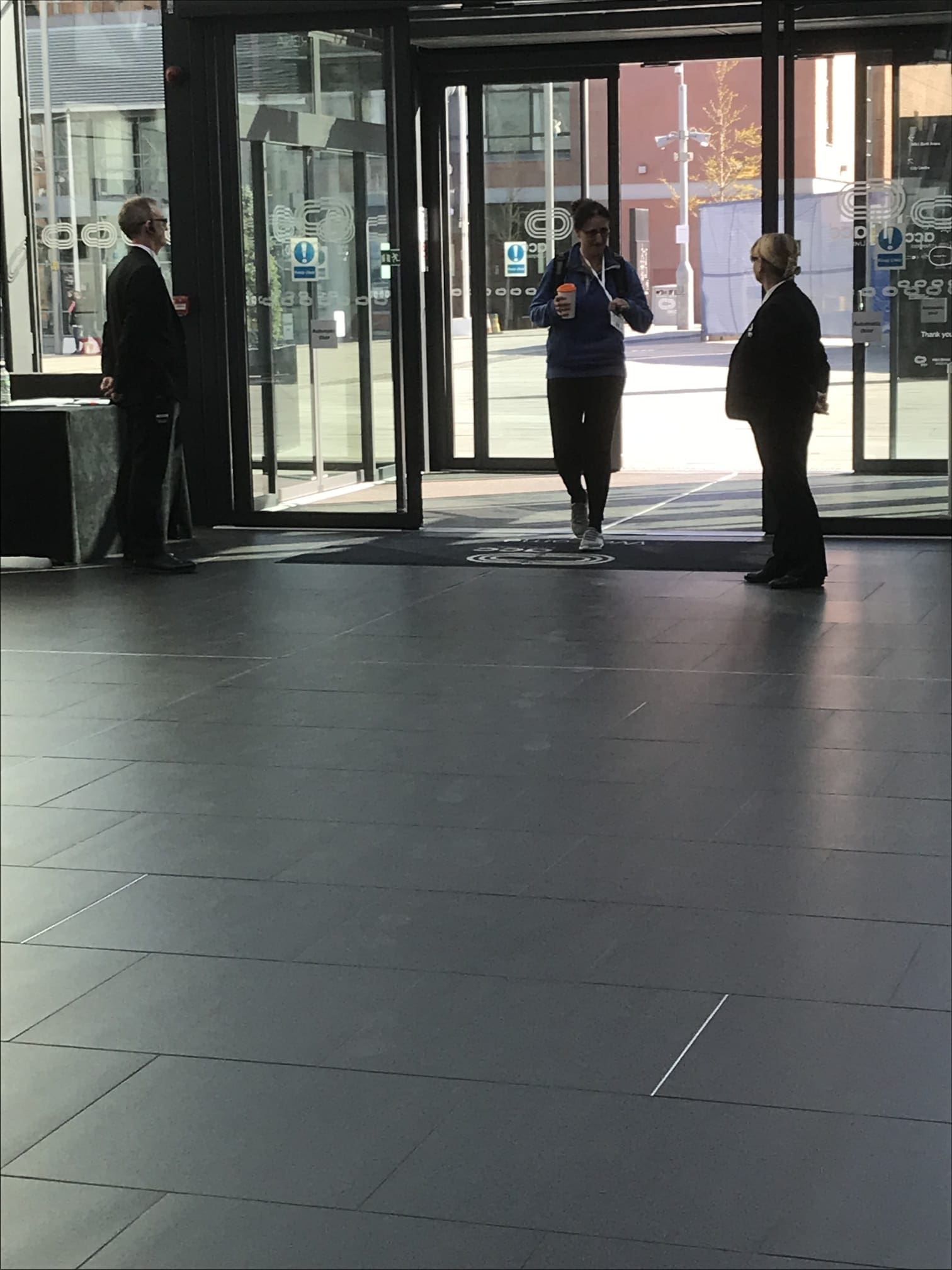 Security officers managing visitor access at a corporate building entrance