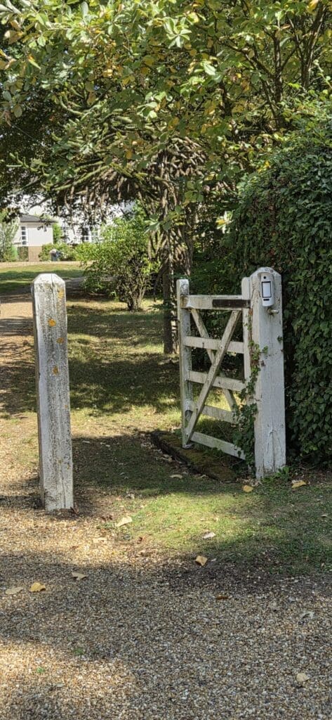 Outdoor perimeter alarm detector protecting a property entrance gate