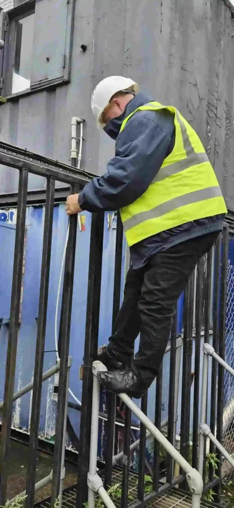 Security consultant identifying a gate climbing vulnerability during a site assessment