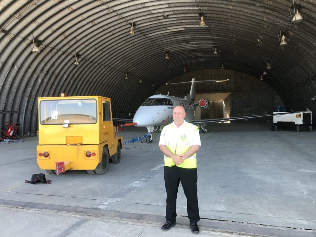 Security guarding in Norwich MW Global Security guard securing a aircraft in a hangar.