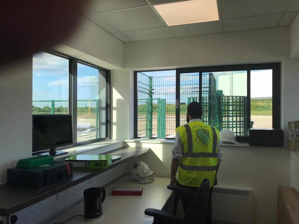 MW Global security officer monitoring access from a commercial site gatehouse